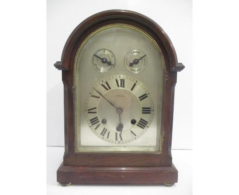 An early 20th century mahogany arched top bracket clock. The silvered dial having Roman numerals, two subsidiary dials for ch