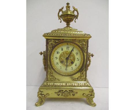 A 19th century French gilt brass mantle clock.  The dial having a pierced gilt centre, ceramic chapter ring with Arabic numer