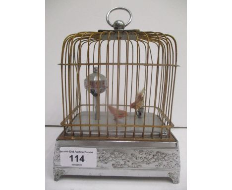 A mid 20th century Japanese novelty automaton table clock modelled as two birds in a cage 7 3/4"h including handle x 5 1/2"w 