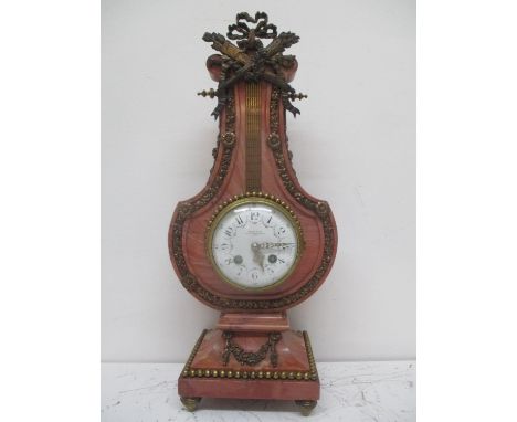 A late 19th century French pink marble and gilt metal lyre shaped clock in the Louis XV1 style. The case having a gilt quiver