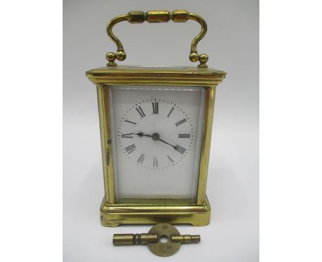 An early 20th century French brass 8 day carriage clock having a white enamel dial with Roman numerals, movement inscribed Ma