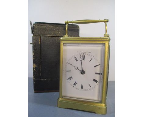 A brass carriage clock with travel case circa 1840 having a white enamel dial inscribed Dixon &amp; Fils A Paris, black Roman