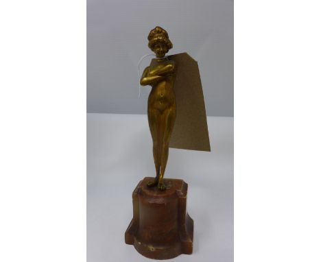 A small Art Deco bronze nude figure with crossed arms on a plinth base, H.24cm 
