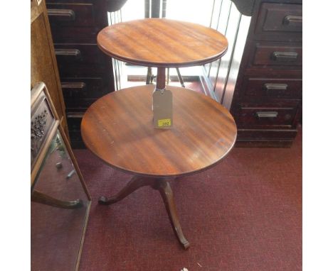 A Georgian style mahogany two tiered dumb waiter on tripod supports 