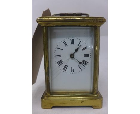 A polished brass carriage clock, with a white enamel dial with Roman numerals, H.11cm 
