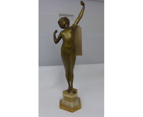 A Paul Philippe (French 1870-1930) Art Deco gilt bronze nude figure, The Awakening,  a sculpture of a nude maiden in a stretc