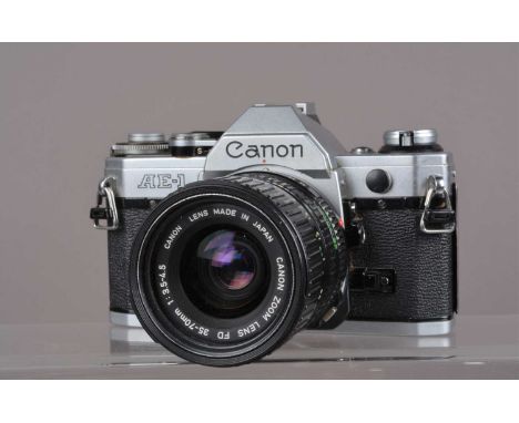 A Canon AE-1 SLR Camera, shutter working, meter responsive, self timer working, body G, with 35-70mm f/3.5-5.6 FD lens, barre