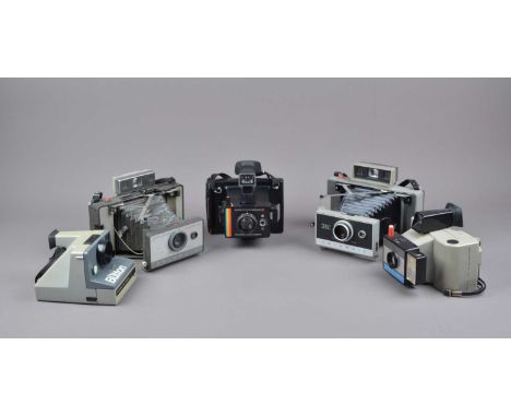 Five Polaroid Cameras, a Polaroid Automatic 330, 130 Land Camera, Swinger II, The Button and a Super Colour Swinger II, all u