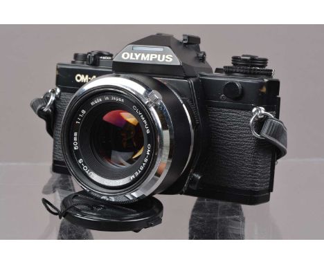 An Olympus OM-4 SLR Camera, shutter working, meter responsive, self timer working, appears to function as should, body G, som