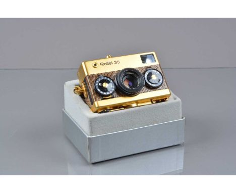 A Rollei 35 Gold Camera, made in Singapore, 24 Karat gold plated, with lizard skin body, shutter working, meter unresponsive,