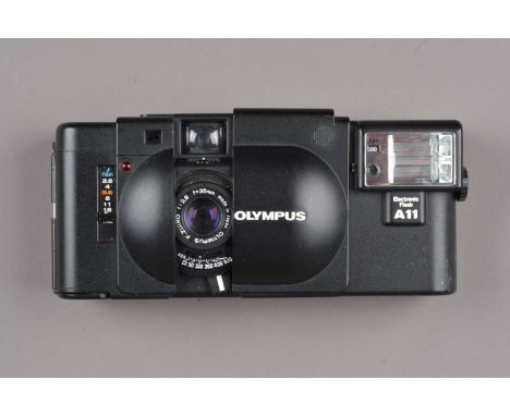 An Olympus XA Compact Camera,  shutter working, self timer working, body G-VG, some light scratches/wear to back,  elements G