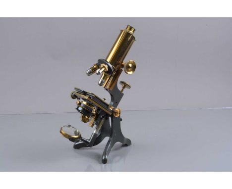 An early 20th Century Lacquered and Anodised Brass Baker Compound Monocular Microscope,  with draw-tube eyepiece, triple nose