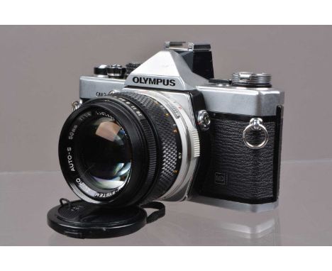 An Olympus OM-2n MD SLR Camera, shutter working, meter responsive, self timer working, responsive in auto mode, body G-VG, wi