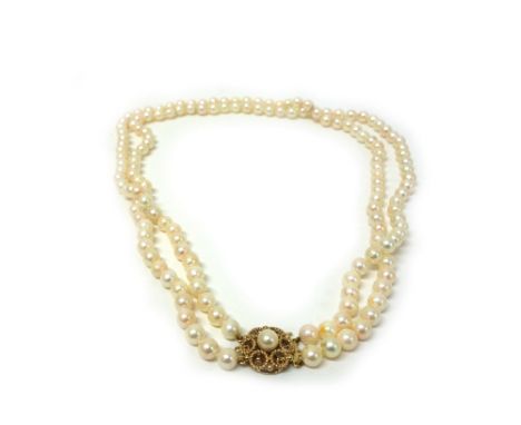 A two row cultured pearl necklace on 9ct gold circular clasp, 76 and 73 beads approx 6.5mm diameter, 56cm long. 