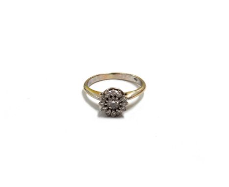 A modern 18ct white gold and diamond cluster ring, centred with a round brilliant approx. 0.17cts, within a tiny diamond twel