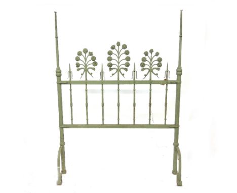 An ornate green painted cast iron and wrought metal headborad or room divider, 19th century and later, with ring turned uprig