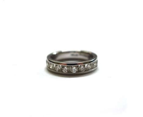 A diamond half-eternity ring, twelve brilliant cut stones in a white gold channel setting, London 1950, makers mark BP number