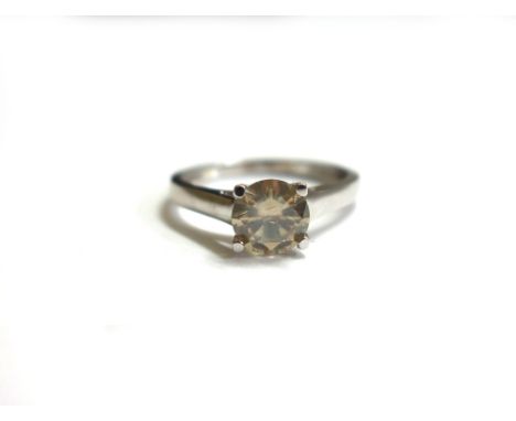 A diamond solitaire ring, the tinted modern round brilliant measures approx. 6.75mm x 3.7mm and weighs approx. 1.01cts, in a 