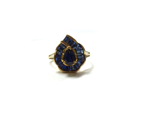 A 9ct gold and sapphire pear shape cluster ring, claw set at the centre with a pear-shaped sapphire, within a baguette and ta