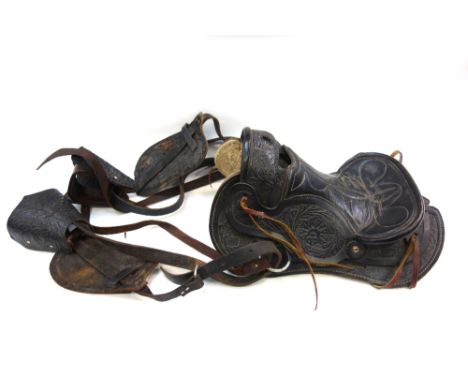 A Western embossed black leather saddle and two black leather ammunition belts and pistol holsters (3).