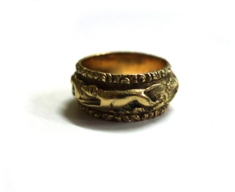 A 19th century gold-plated 'fox hunt' band ring, the central panel depicting hounds chasing a fox in high relief between flor