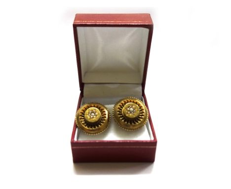 A pair of Victorian gold and cultured pearl round panels, later adapted as clip earrings, each centred with a graduated cultu