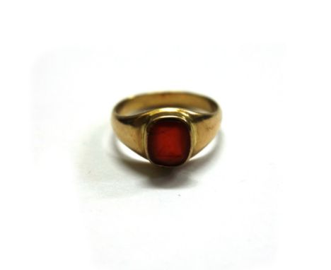 A late 19th century gold and carnelian oblong signet ring, the seal engraved with a stylised dog, rub-over set within a taper