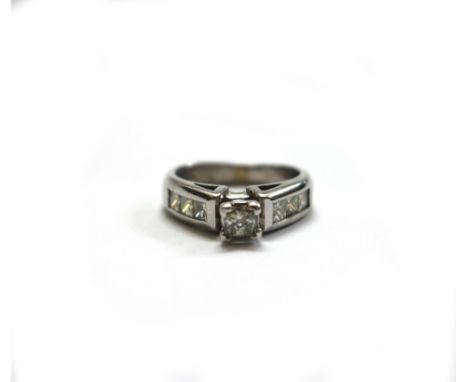 A 14ct white gold and diamond dress ring, centred with a princess-cut diamond approx. 0.25cts, four claw set between princess