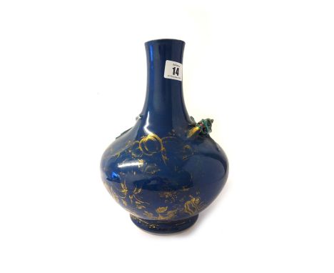 A Chinese bottle vase, 18th century, the powder blue ground applied with a dragon with green and black scales and heightened 