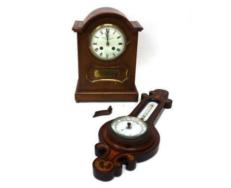 An Edwardian walnut arched top case mantel clock, signed Thomas Armstrong & Brs, Manchester, 30cm high, applied presentation 