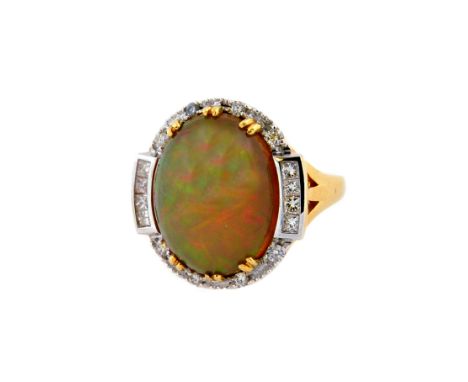 An 18ct gold, opal and diamond cluster ring, centred with a large oval opal cabochon, rub-over set within a closed-back mount