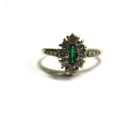 A 9ct gold, emerald and diamond set marquise shaped cluster ring, between diamond set three stone shoulders, ring size P. 