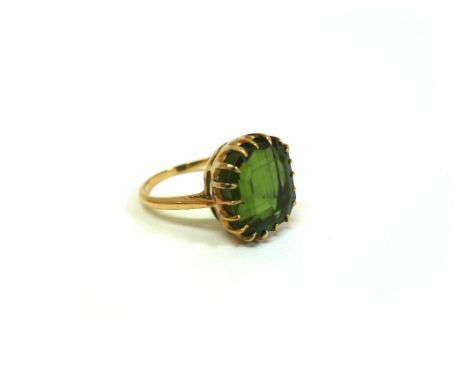 A gold and green tourmaline ring, the stepped rectangular-cut stone measuring 13.0 x 11.8 x 8.0mm, in a claw setting, unmarke