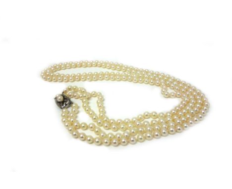 A two-row cultured pearl necklace on a pierced and engraved white metal and cultured pearl set clip, approx 82.5cm long, unma