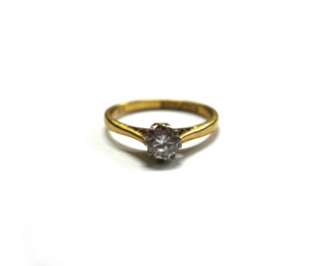 A diamond solitaire ring, the round brilliant cut stone approx. 0.35cts, claw set in white to a yellow shank, stamped '18ct P