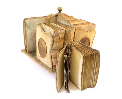A Set of Eight Regency Hand-Blocked Linen-Bound Albums, with foliate decoration, in a matching single-tier revolving bookcase
