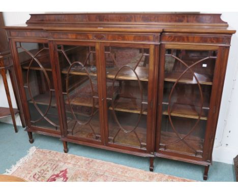 A mahogany breakfront bookcase with four glazed doors on square tapering legs, 130cm high x 183cm wide x 33cm deep Condition 