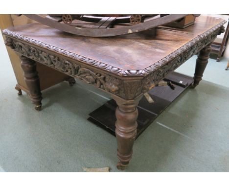 A Victorian oak wind out extending dining table with carved frieze and two leaves on turned legs, 75cm high x 240cm wide x 12
