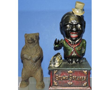 A cast iron money box, in the form of a Stump Speaker, H. 24cm; together with a money box in the form of a bear. (2)