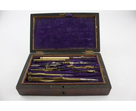 A rosewood cased drawing instrument set, the hinged lid with a rectangular vacant cartouche enclosing a fitted tray with equi