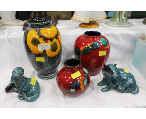 Three Poole vases, two Poole animal figures, otter and badger 