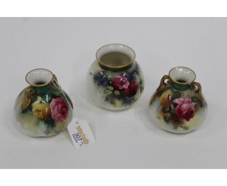 Three Royal Worcester vases decorated with floral sprays and with gilt rims