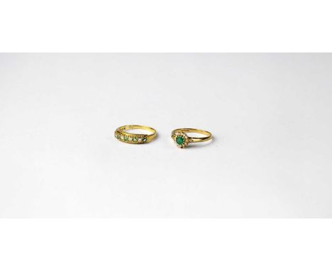 Two 9ct rings set with emeralds and diamonds, one a cluster ring, size M, the other a band ring with alternating stones, size