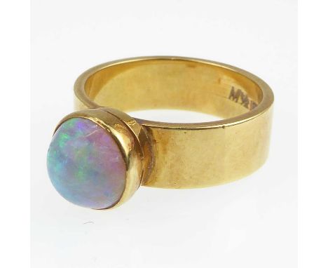 An 18ct gold contemporary opal ring, bezel set opal with greens and blues, size M/N, approx. 7g.Condition Report: Opal is app