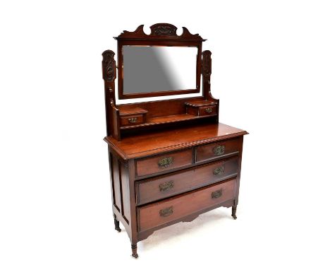 An early 20th century walnut dressing chest with bevelled mirror plate above two short jewellery drawers and open shelf, abov