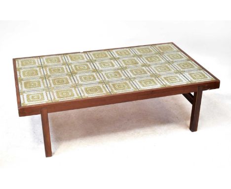 A vintage tile top coffee table within a teak frame, raised on square section supports, 42 x 146 x 86cm.