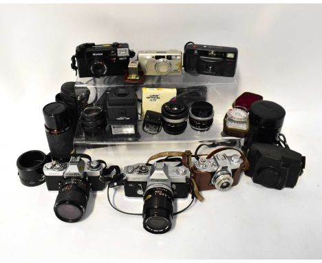 A collection of cameras and accessories to include a Canon FT SLR camera fitted with a Canon FD 135mm 1:3.5 lens, a Minolta X