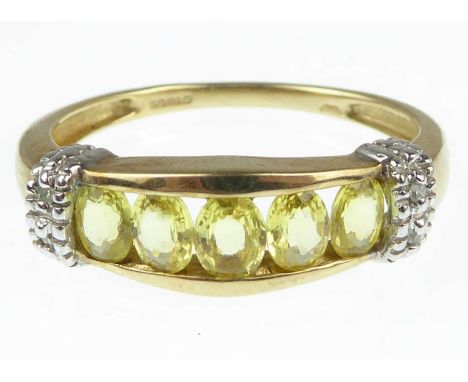 A 9ct gold dress ring with five tension set yellow marquise cut stones, with a white collar either side of tiny diamonds, siz