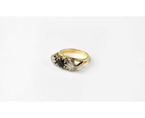 An 18ct gold ring set with central blue stone and two diamonds, approx. 0.2ct, stamped 750, size K, approx. 4.8g.