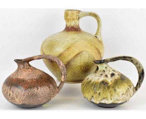 WEST GERMAN POTTERY; three ceramic jugs of squat form, two pattern no.313 with different finishes, 16 x 16cm, together with a
